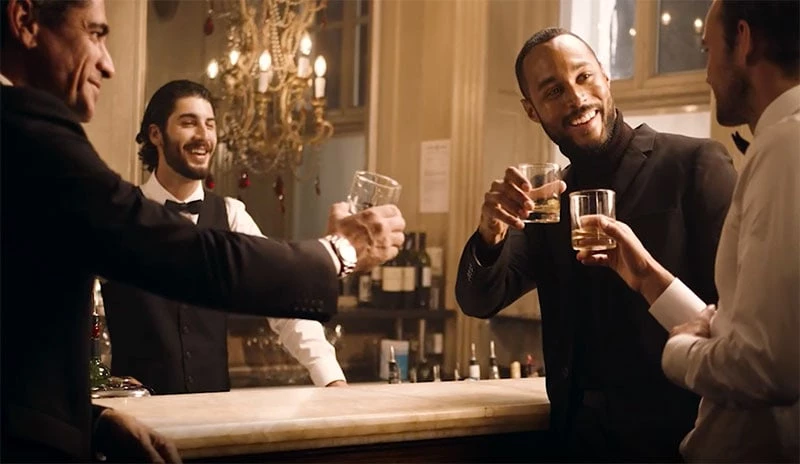 People drinking rum with a bartender