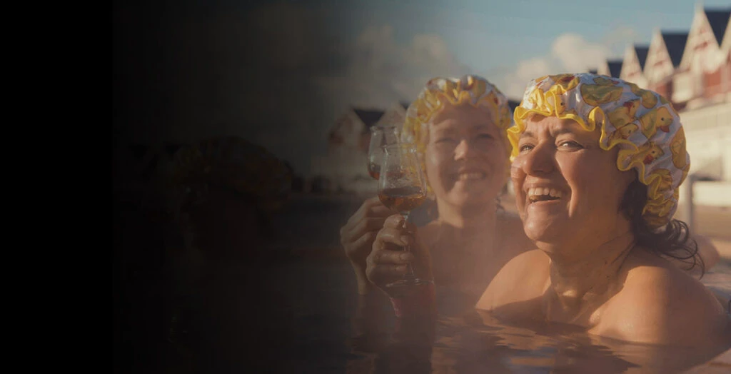 two women bathing with bathing hats